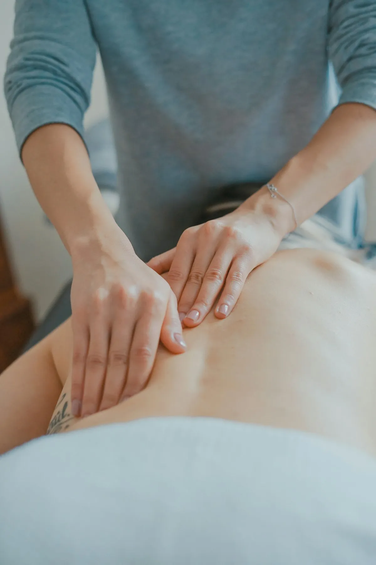 Therapist performing a back massage